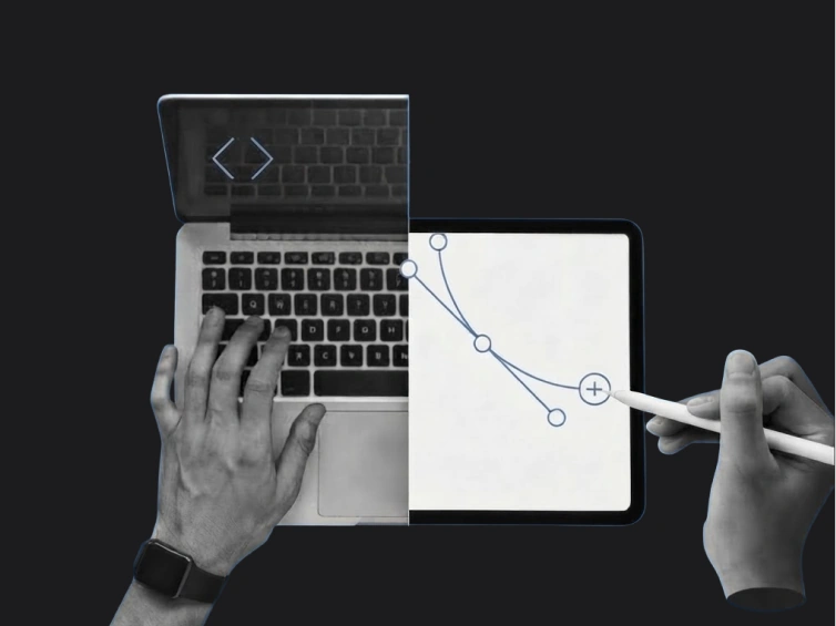 Developer coding on a laptop beside a tablet wireframe sketch